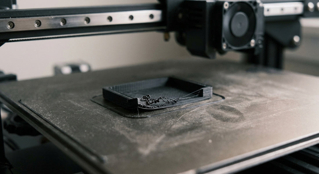 Wydruk 3D z odklejoną pierwszą warstwą na stole drukarki — typowy problem z przyczepnością